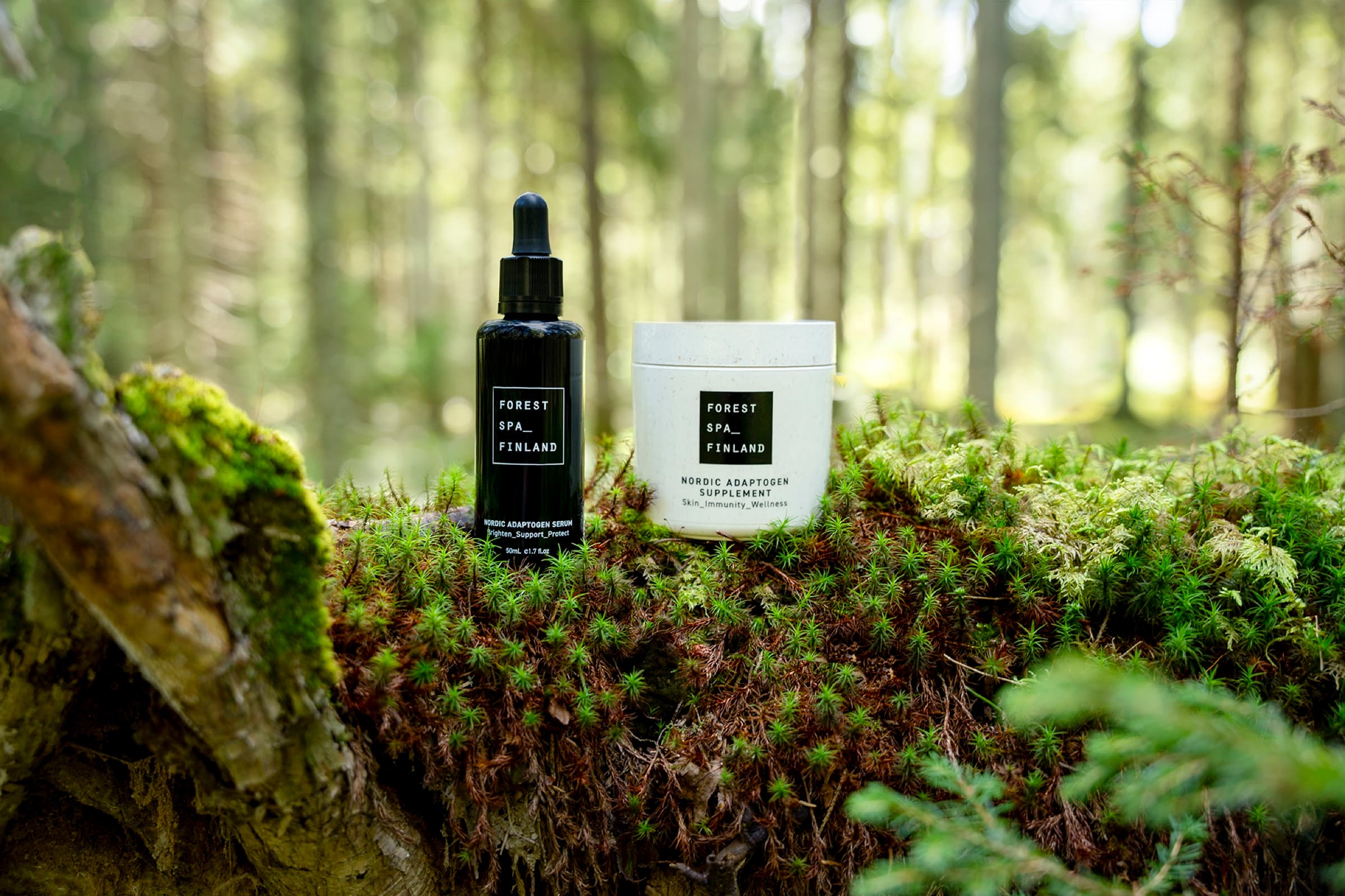 Forest Spa Finland Nordic Adaptogen Serum and Supplement resting on moss in a boreal forest