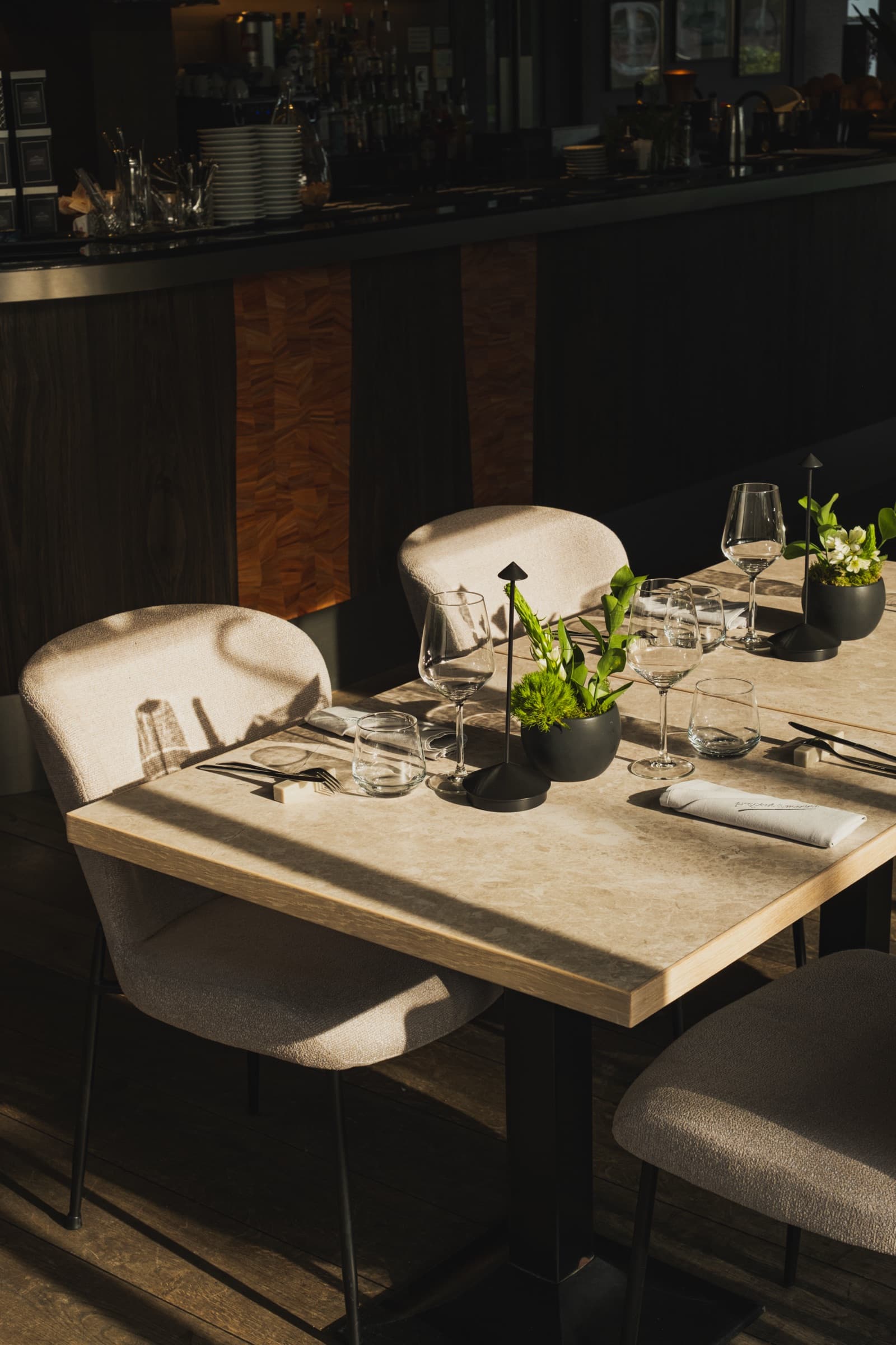 Przystań & Marina — dining table setting with natural light and bar in background